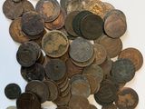 a pile of old coins on a white surface