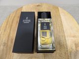 an image of a bottle of perfume sitting on top of a wooden table