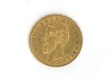a close up of a gold coin on a white surface