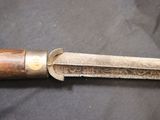 a knife with a wooden handle on a black surface