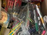 a cardboard box full of school supplies and supplies