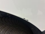 a close up of a car ' s front bumper and fender