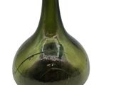 a green glass bottle with a hole in it