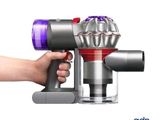 a close up of a person holding a small blow dryer in their hand