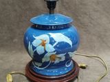 a blue vase with a gold fish design on it
