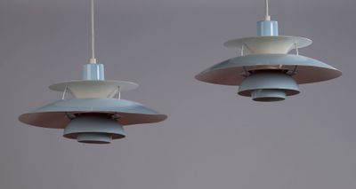 two light fixtures hanging from the ceiling of a room