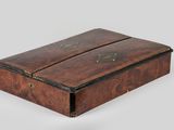 an old wooden box with two compartments on top of it