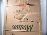 a cardboard box with a pair of shoes on top of it