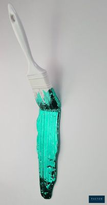 a paint brush with green paint on it on a white wall