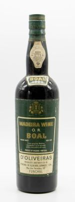 an old bottle of wine sitting on top of a white surface