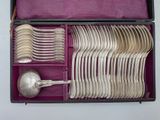 a box with a bunch of silver spoons in it