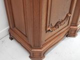 a wooden cabinet with a mirror on top of it