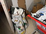 a shopping cart with bags of items in it