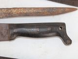 two old rusty knives on a table next to each other