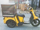 a yellow scooter with a box on the back of it
