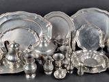 many pieces of silver on the table together