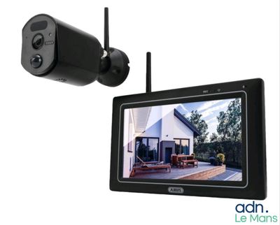 a close up of a camera and a monitor on a wall