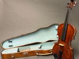 a violin and a violin case sitting on a table