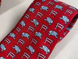 a red tie and a blue and white tie on a white table