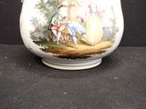 a white vase with a painting on it sitting on a table