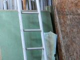 a ladder that is leaning against a building