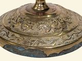 a gold and blue vase with a bird on top of it