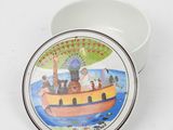 a white bowl with a painting of a boat with people on it