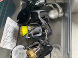 many fishing rods and reels in a plastic container
