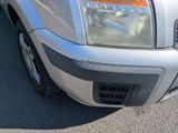 a close up of a car ' s front bumper and headlight