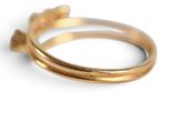 an image of a close up of a gold ring on a white surface