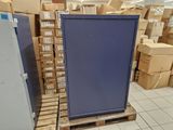 a blue refrigerator in the middle of a room full of boxes