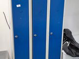 two blue lockers in a room with a trash can