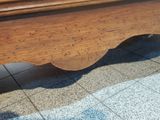 a wooden bed with a wooden headboard on top of it