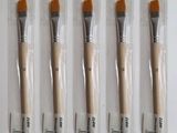 four brushes in a package with a price tag on them