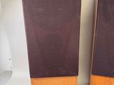 two speakers sitting on top of a table next to a speaker