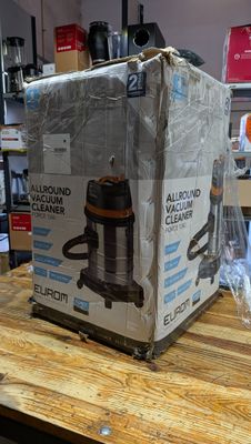 a box that is sitting on a table with a vacuum on it