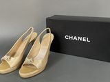 a pair of chanel shoes sitting next to a box