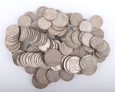 a pile of silver coins on a white surface