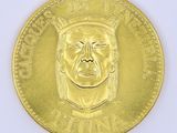 an image of a gold coin with a man ' s face on it