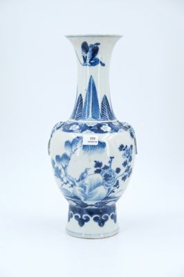 a blue and white vase sitting on a white surface