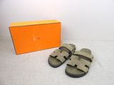 an orange box with a pair of sandals and a pair of sandals