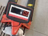 a caliper that is on top of a piece of wood