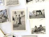 several old black and white photos of people and horses on a table