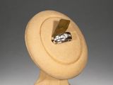 sculpture of a ring on a stand with a ring in the middle