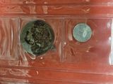 a red chest of drawers that has coins on it