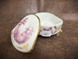 a small bowl with a lid that has a picture of a woman on it