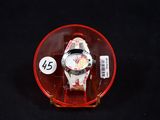 a watch in a red case on a black surface
