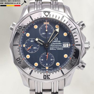 a close up of a watch with a blue dial