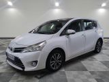 the white toyota yaris is parked on a checkered tile floor