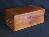an old wooden box sitting on top of a black cloth